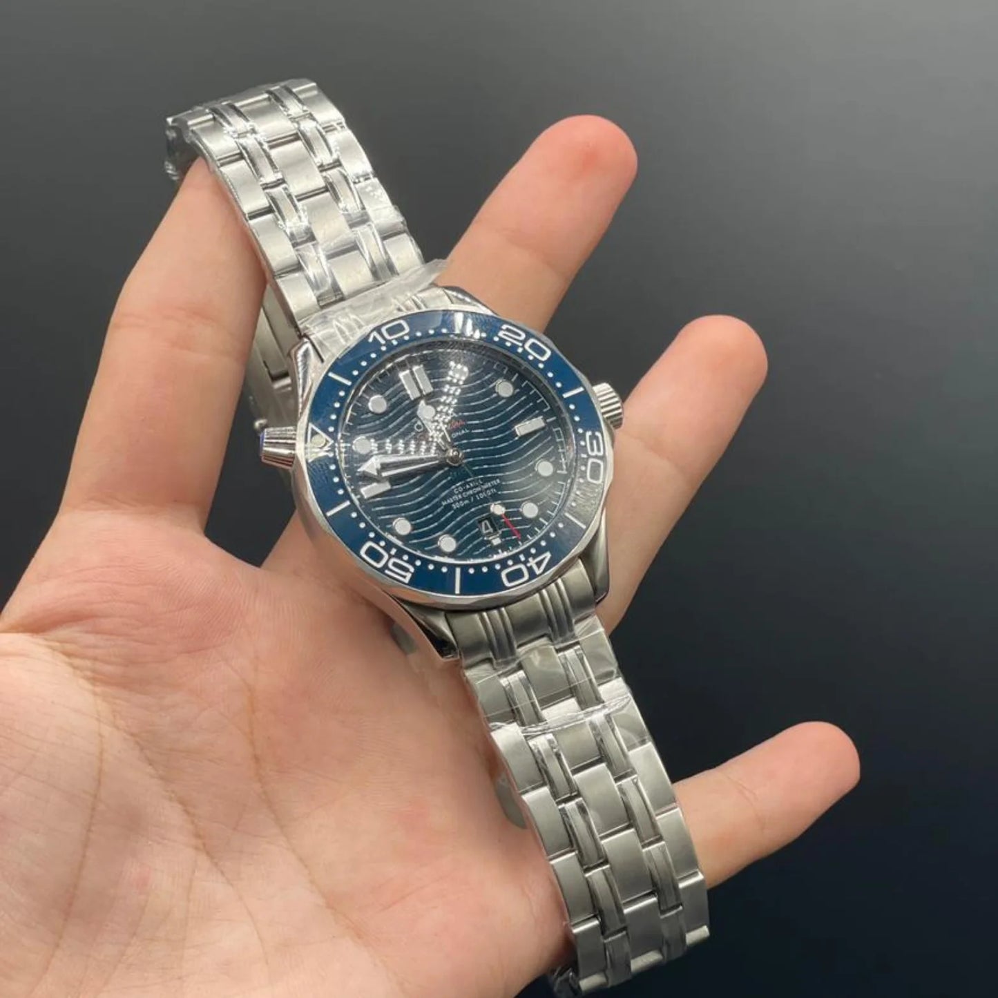 OM Silver Chain With Blue Dial And Blue Rotatable Bezel Automatic Watch