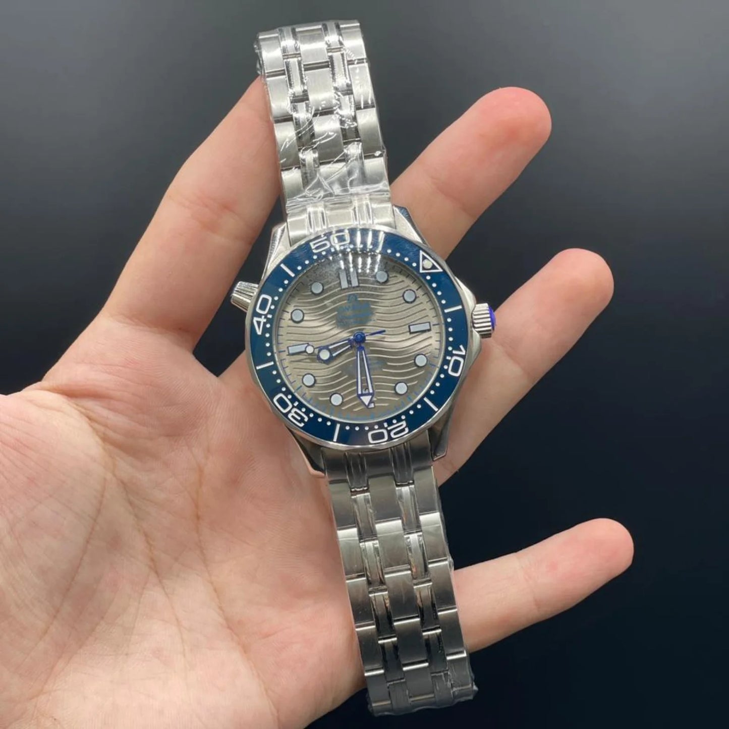 OM Silver Chain With Gray Dial And Blue Rotatable Bezel Automatic Watch